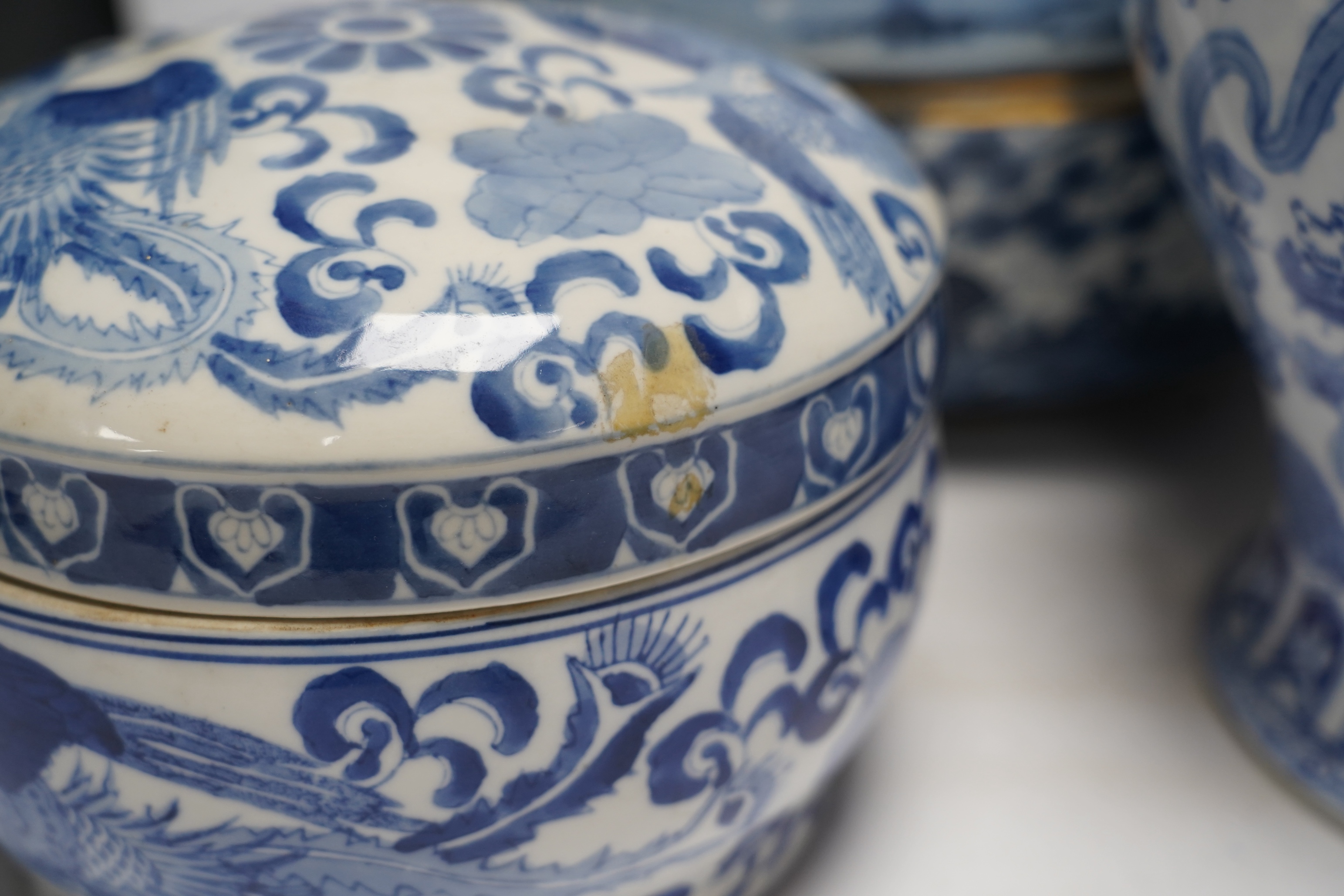 A 20th century Chinese blue and white vase and cover, a large bowl and cover and a smaller bowl and cover, tallest 44cm